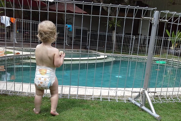 photo of infant near temporary pool fence