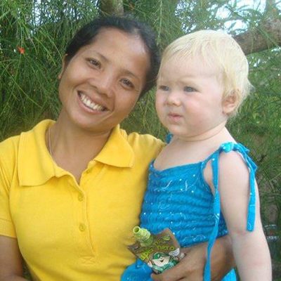 photo of Nanny Dany with baby girl in blue dress